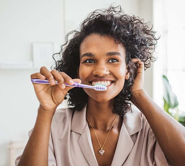 woman brushing her teeth