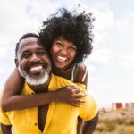smiling Black couple after professional teeth whitening
