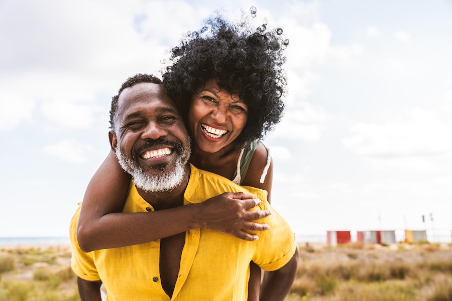 smiling Black couple after professional teeth whitening