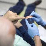 patient getting new dentures, eating with dentures