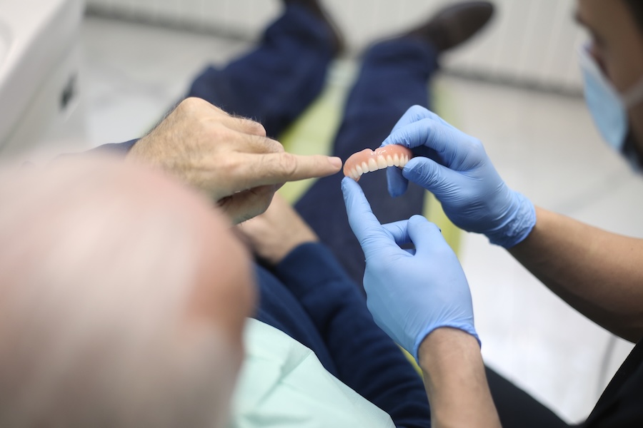 patient getting new dentures, eating with dentures